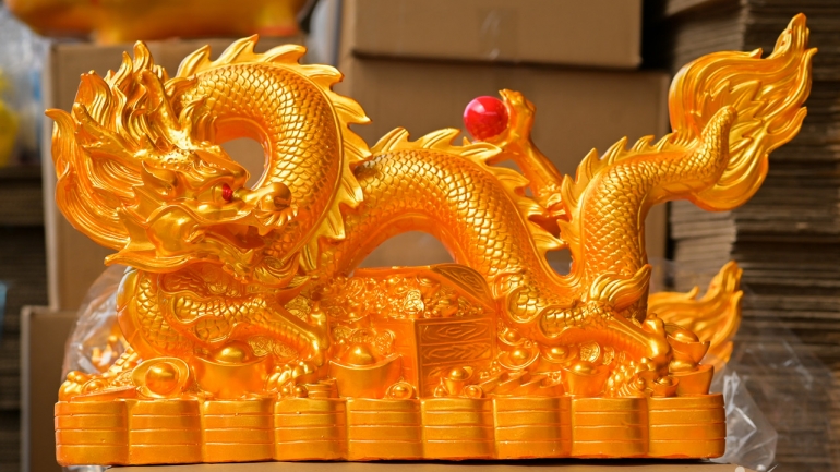Crafting clay dragon-shaped money savings boxes for Tet celebration