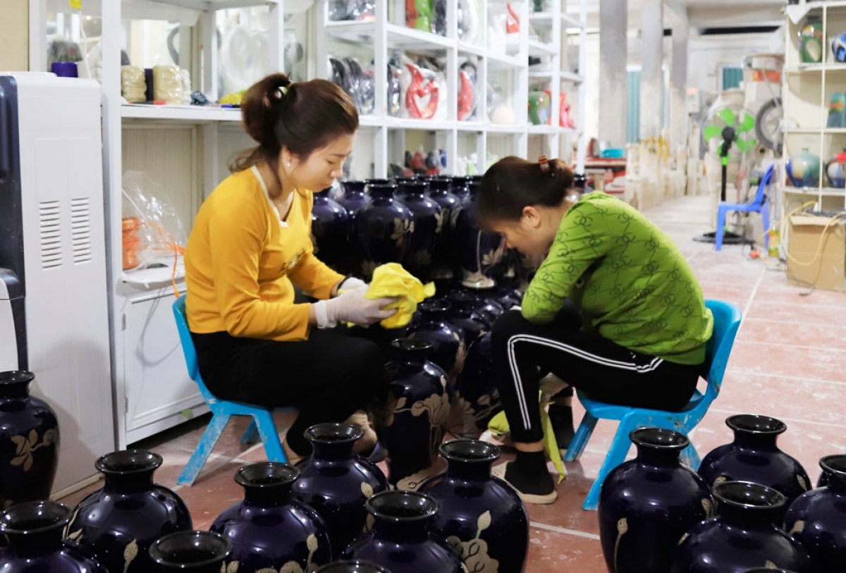 Workers in Bat Trang ceramic village in Gia Lam district clean items as they step up production to meet demand ahead of Tet.