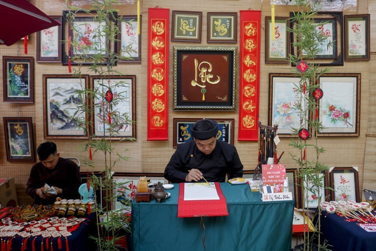 A young calligraphy artist gets to work on his craft.