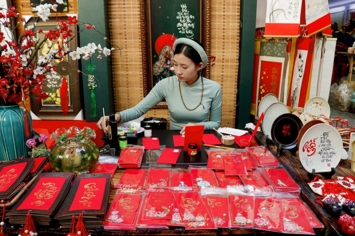 A young girl practices as a calligraphy artist.