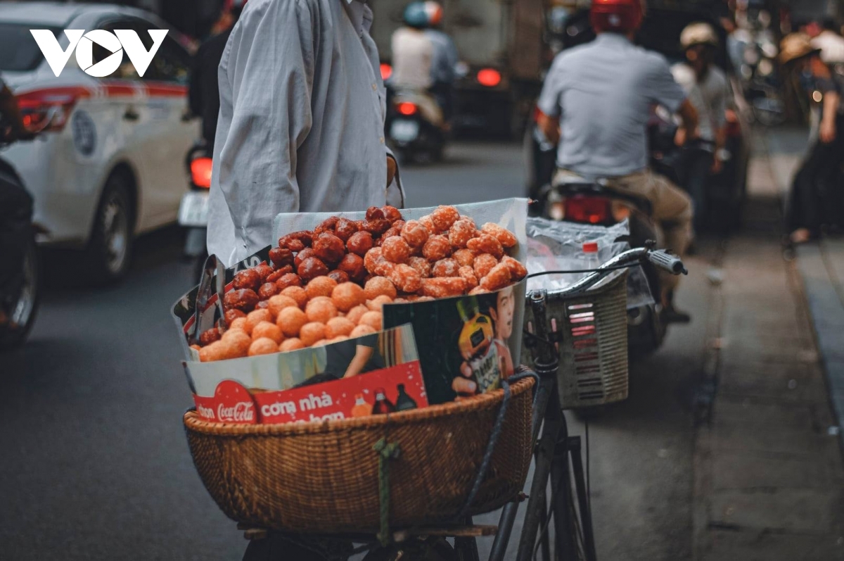 Street vendors bearing food items such as cakes, candy, and ice cream, along with fruit and vegetables, operate throughout Hanoi.