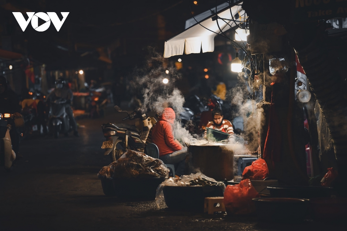 A small stall sells food at night.