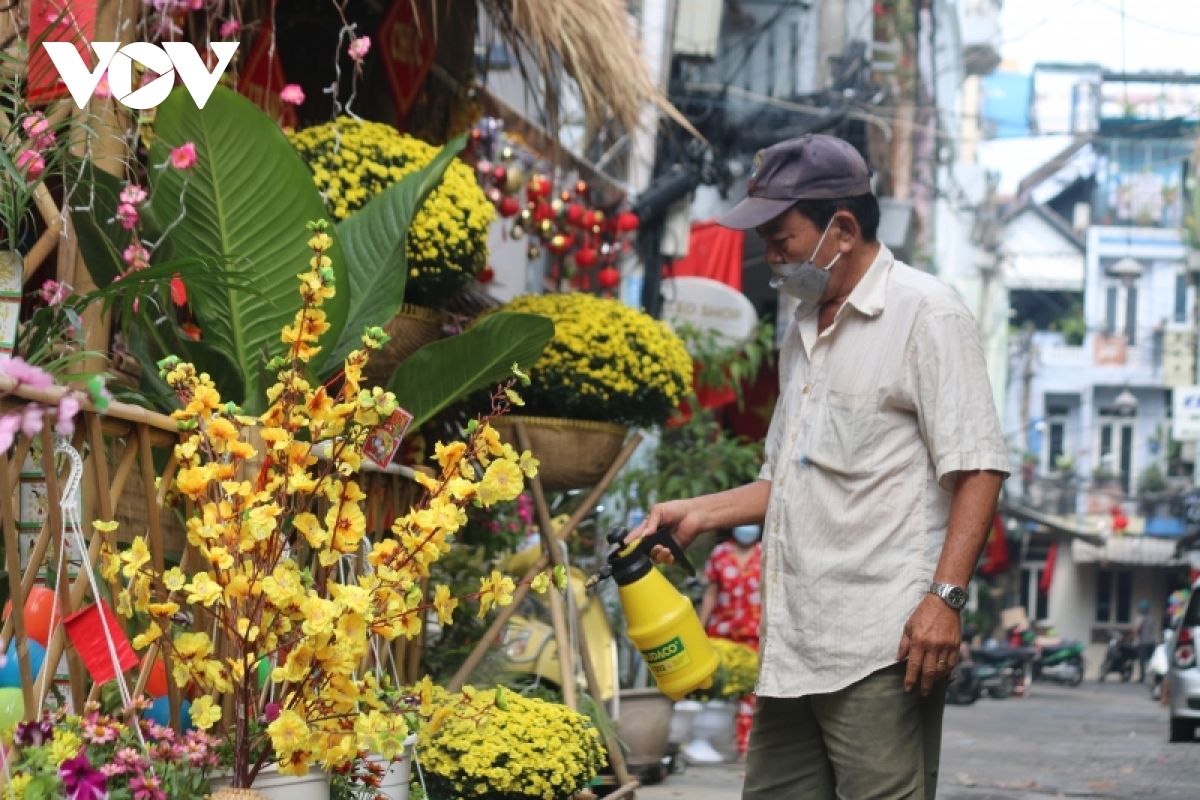 These days people are busy with cleaning and decorating their house to celebrate the holiday. In the photo, a local man is taking care of his flower pots.