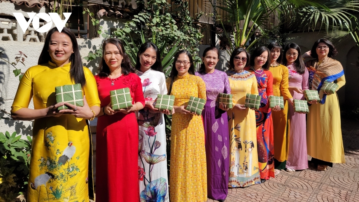 Women in Ao Dai, which are traditional long dresses that local people often wear during special occasions, take photos to keep as memories for Tet.