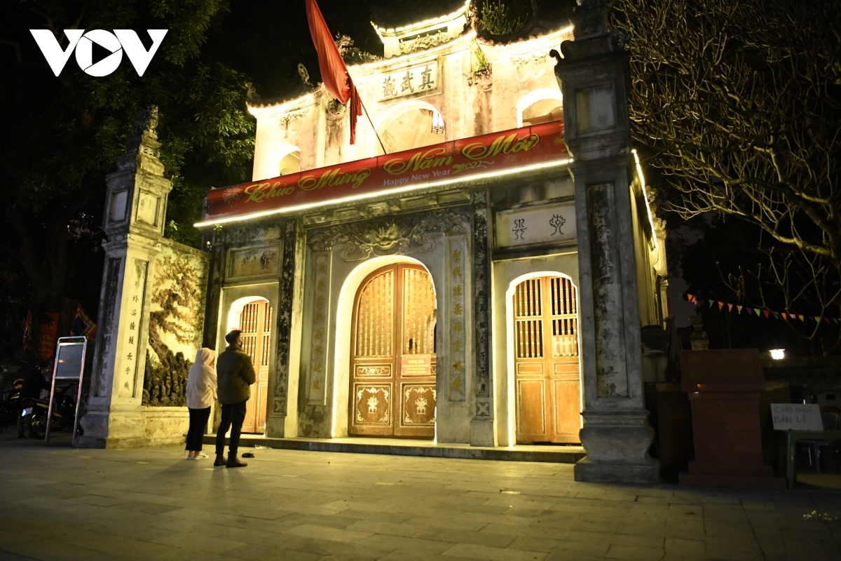 Local people perform a worshipping ritual outside of the Quan Thanh Temple as the site is forced to close amid COVID-19 fears.