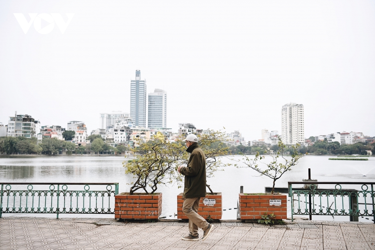 An old man heads out for a stroll to enjoy the fresh air on the first morning of the Lunar New Year.