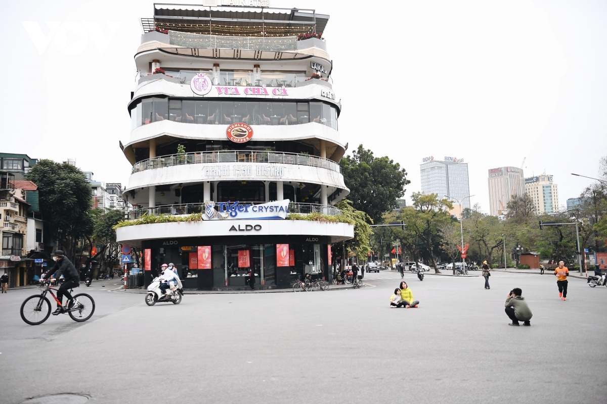 A woman and her children come together to pose for a photo on a quiet street in the capital.