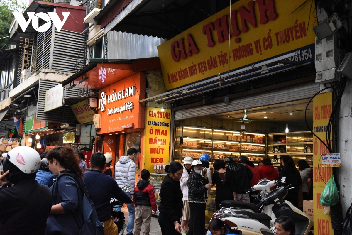 Customers line up in front of a stall on Hang Duong street as they prepare for Tet.