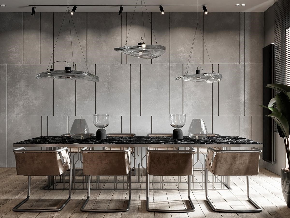 Bộ đèn treo bằng thủy tinh độc đáo tạo thành bộ ba sắc nét, được thiết kế với độ cao khác nhau phía trên bàn đá cẩm thạch đen. Ghế ăn hiện đại được sử dụng vải bọc màu nâu ấm áp, tạo cảm giác dịu nhẹ.