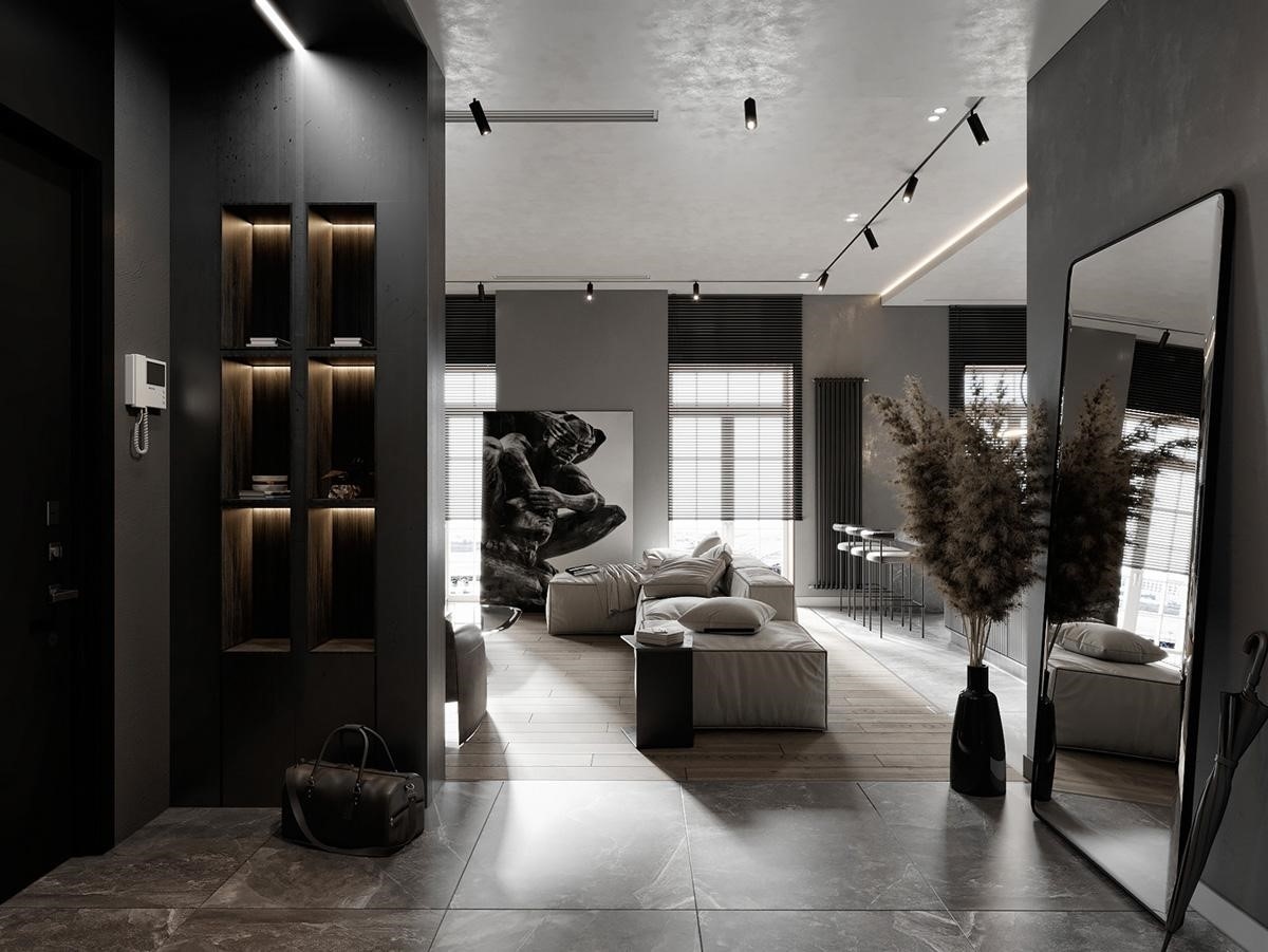 Kệ trưng bày được xây dựng thành một bức tường ngăn (bên trái lối vào căn nhà); kết hợp với đó là những bóng đèn LED trong mỗi hộc tủ tạo sự khác biệt. Một chiếc gương soi toàn thân tạo thành một khu vực thay đồ thuận tiện giúp kiểm tra trang phục trước khi rời khỏi nhà.