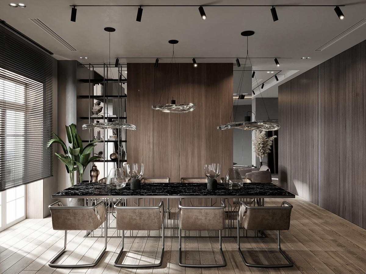 Phòng ăn được thiết kế sang trọng nằm ở phía đối diện bức tường lò sưởi. Một bàn ăn bằng đá cẩm thạch màu đen tạo nên một điểm nhấn sáng tạo trong không gian sống hiện đại.