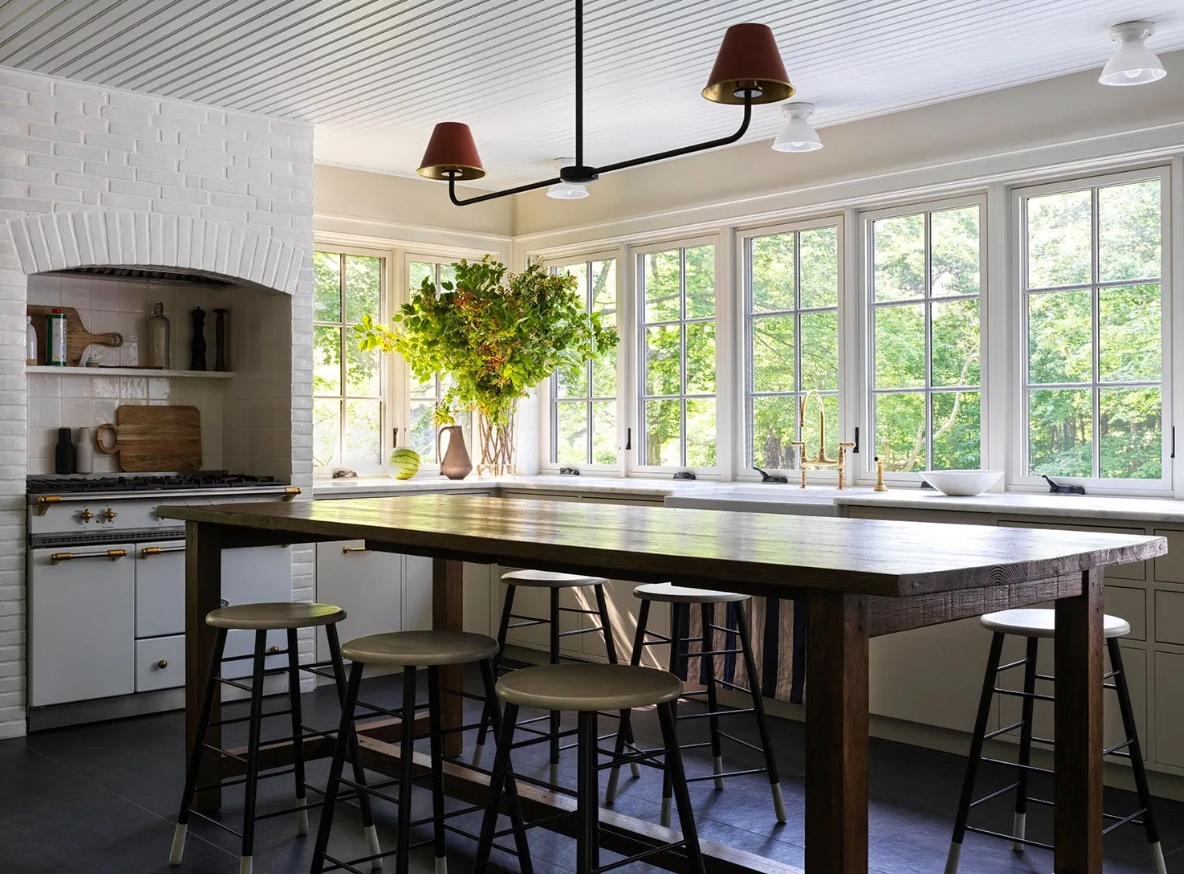 Đối với những người thích phong cách tối giản, bạn không nên bỏ qua thiết kế này. Tủ bếp dạng âm tường được sơn trùng màu với tường, là nơi cất giữ những vật dụng nấu ăn. Bàn ghế gỗ dạng quầy bar với ghế cao, không có nhiều chi tiết trang trí giúp căn phòng trở nên gọn gàng hơn.