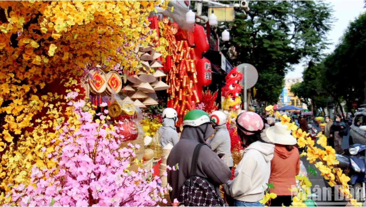 Walking along the 500-metre long street allows pedestrians to see plenty of peach and apricot flowers made of cloth and plastic being used for decoration.