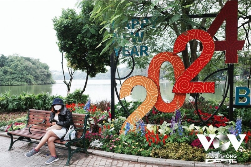 The banks of Ho Guom, also known as Returned Sword Lake, provide a beautiful background for many people to come and take photos for the upcoming lunar year of the dragon.