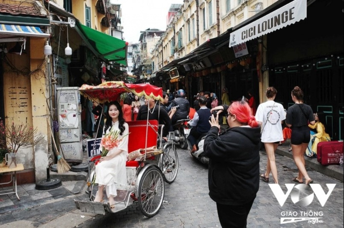 Groups of young people pose for photos in Hanoi’s Old Quarter as they snap memories of Tet.