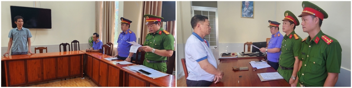 Điều tra viên tống đạt Quyết định khởi tố bị can đối với Trần Quốc Anh (trái) và Nguyễn Văn Nhưỡng 