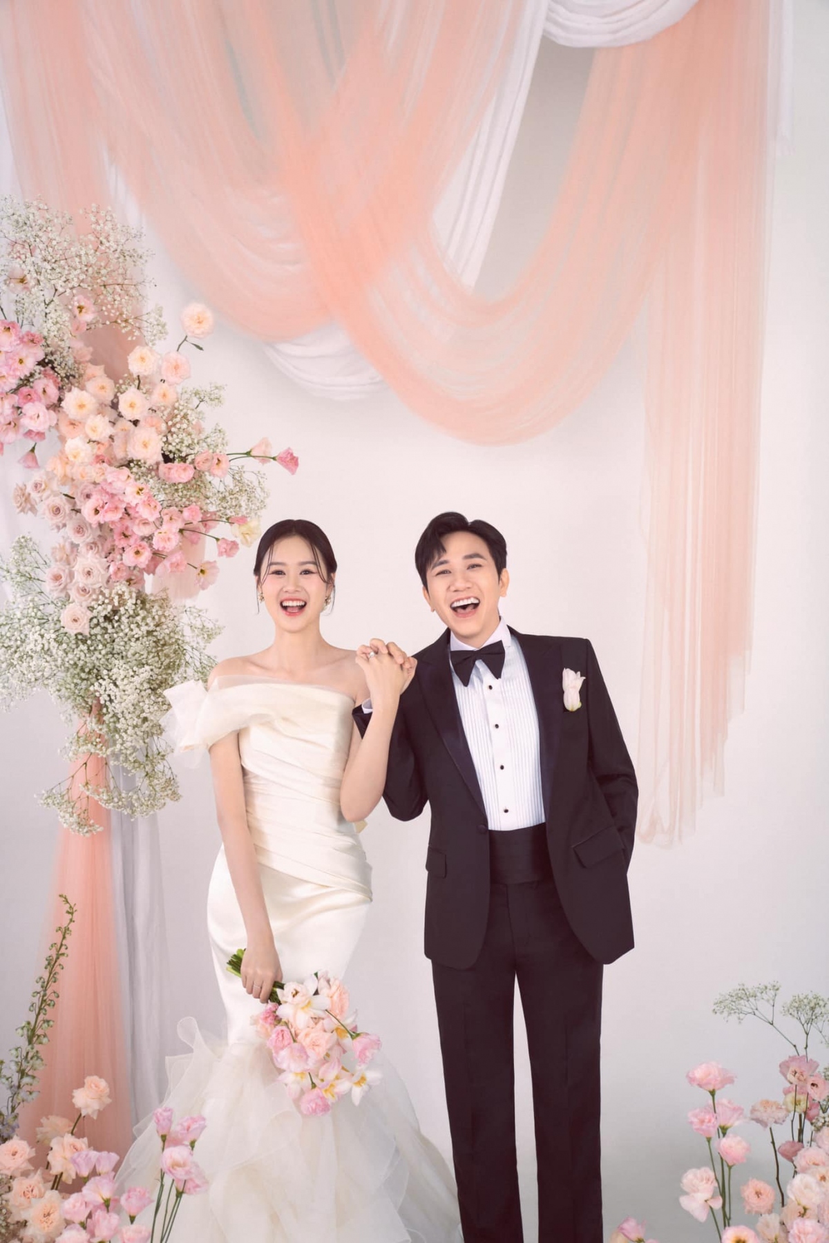 Trong bộ ảnh, Anh Đức lịch lãm trong bộ vest đen, còn cô dâu Quỳnh Anh toát lên vẻ dịu dàng với chiếc đầm lệch vai dáng đuôi cá, khoe trọn đường cong quyến rũ.