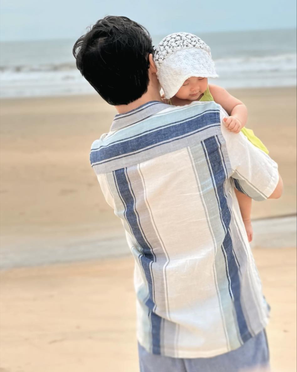 Hoa hậu Đặng Thu Thảo tiết lộ ảnh con gái út được ba ẵm bồng dạo chơi ở bờ biển, biểu cảm khi ngủ say được fan khen 'như búp bê'.