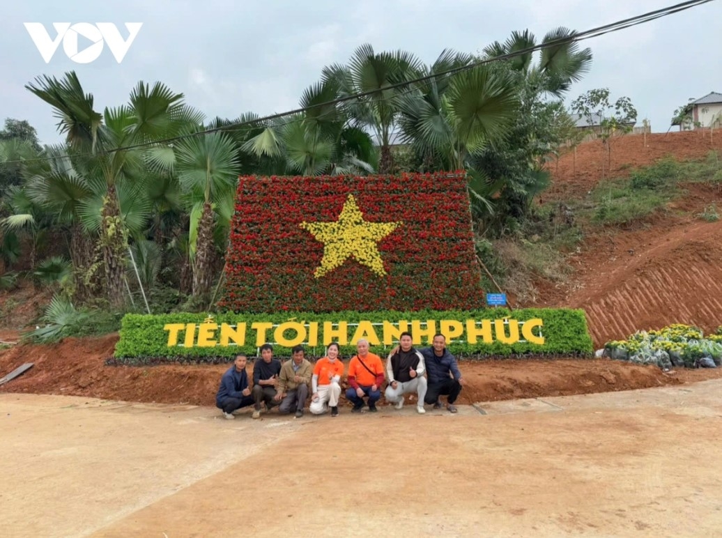 A national flag made of 6,000 pots of flowers is placed in the middle of the vicinity, helping to stabilise the lives of people affected by the catastrophic landslides and flooding caused by Typhoon Yagi in September.