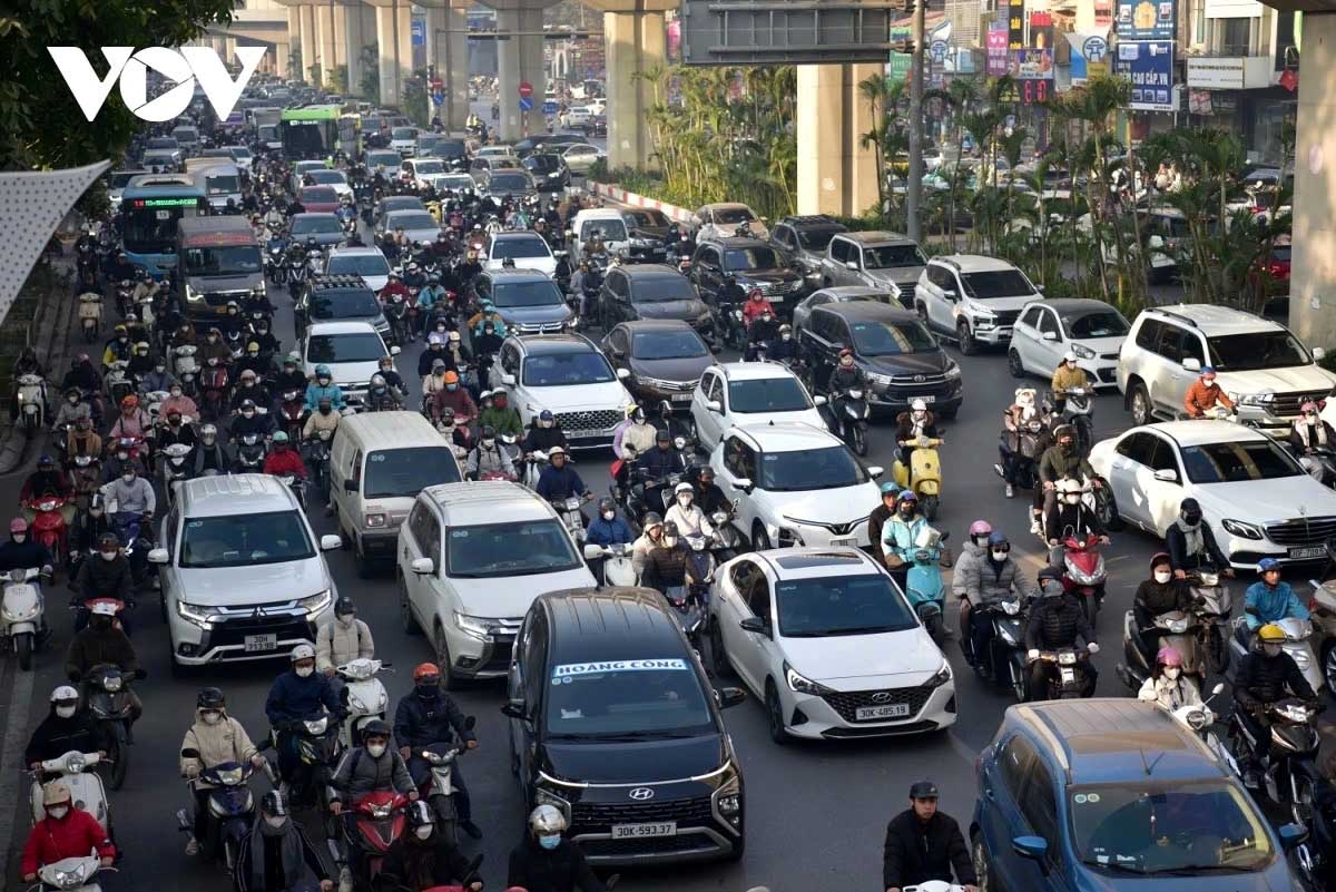 Motorbikes, cars, and even bicycles jostle for space, with pedestrians often spilling onto the roads due to overcrowded pavements.