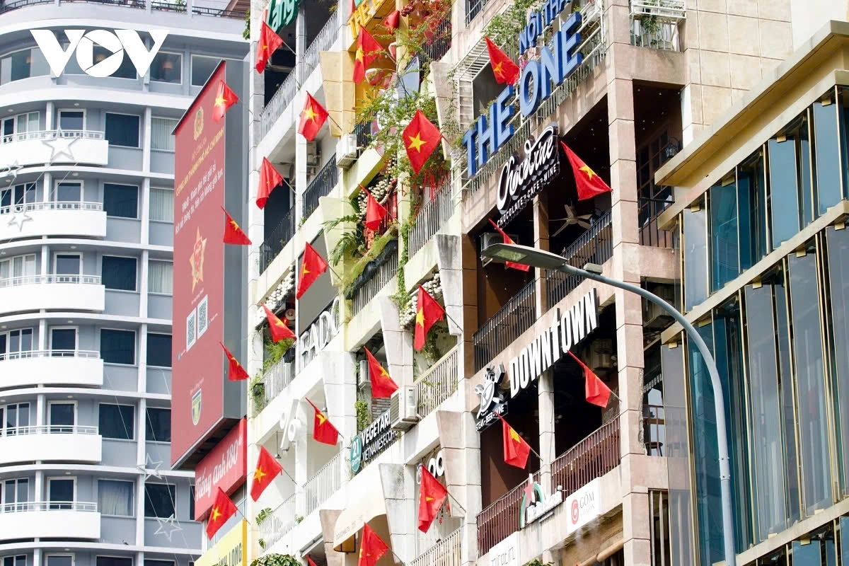 A building on Nguyen Hue Walking Street, District 1, is adorned with the national flag celebrating the founding of the Communist Party of Vietnam.