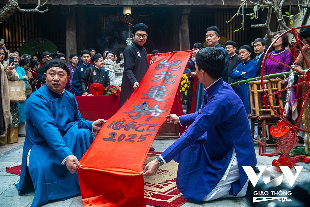 Artisans perform a calligraphic piece of work featuring the words "Kỷ Nguyên Vươn Mình" (new era). The annual “Tết Việt tết phố” programme will last through to January 25, featuring many other important rituals and cultural activities.