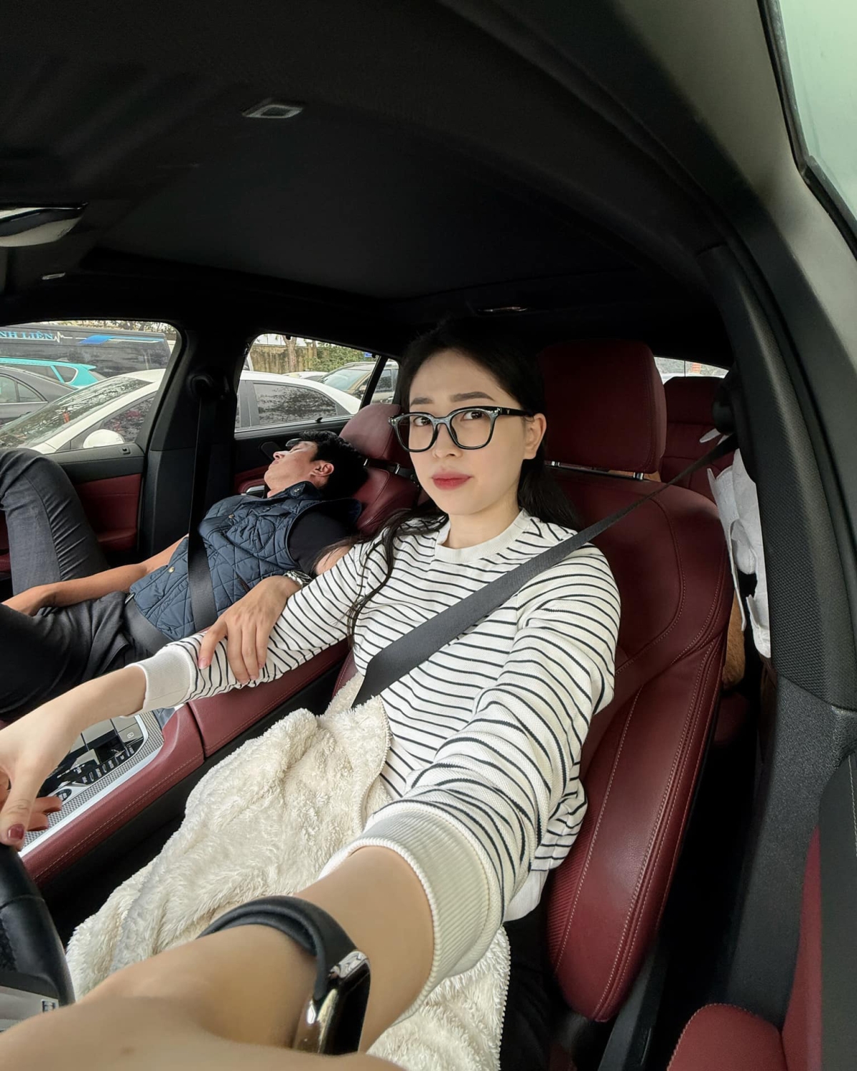 Á hậu Phương Nga làm tài xế trong lúc ông xã Bình An chợp mắt trên xe. Cặp đôi từ quê Phú Thọ lên Hà Nội để chuẩn bị quay lại với công việc sau Tết Nguyên đán. (Nguồn: FBNV)