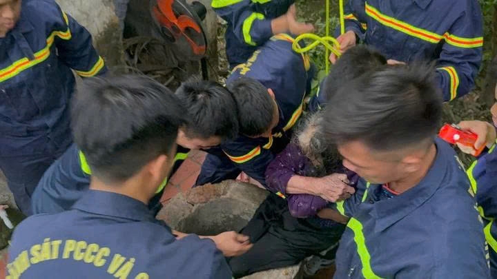 Cụ bà 84 tuổi được đưa ra khỏi miệng giếng. (Ảnh: Công an Bắc Giang)