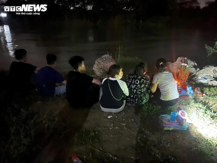 Gia đình nạn nhân ngóng trông trên bờ.