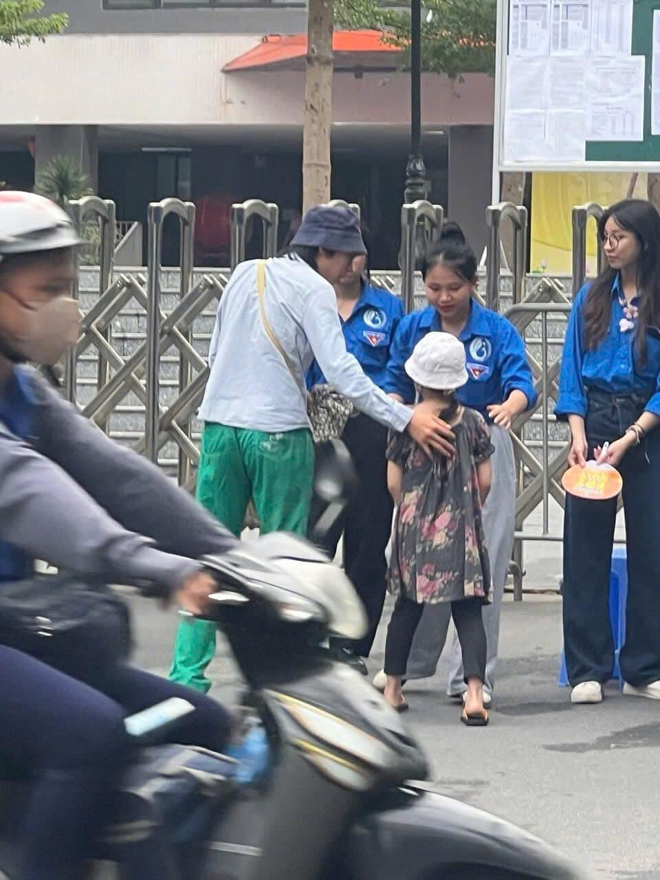 Hình ảnh anh trai đưa em gái đến điểm thi vào lớp 10 chuyên, nhờ tình nguyện viên trông giúp để vào phòng thi.