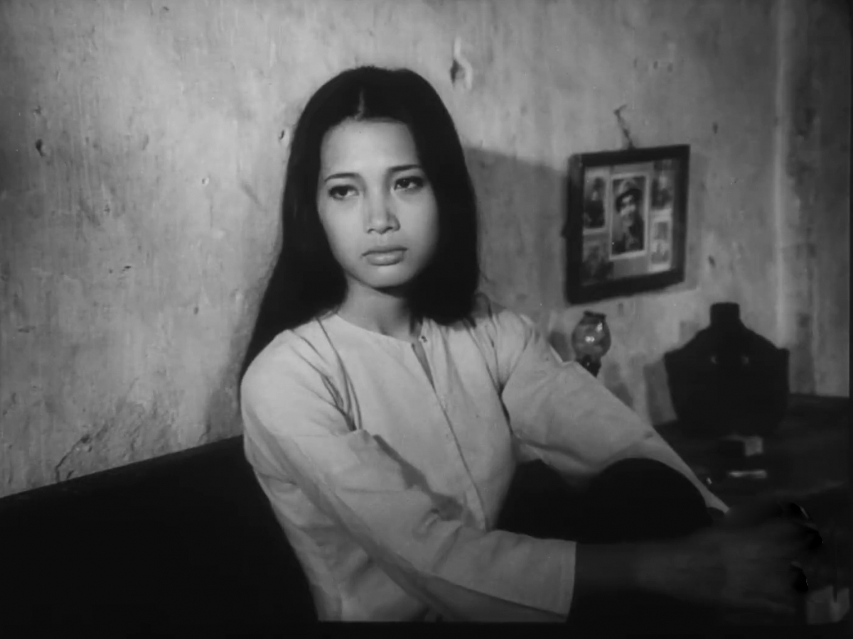 Thủ pháp ánh sáng hắt qua ô cửa soi rõ nỗi đau được nén lại trong ánh mắt của nhân vật Duyên. (Ảnh chụp màn hình phim)