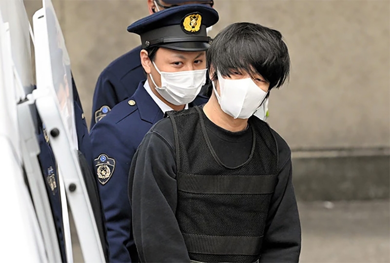 Cảnh sát áp giải Tetsuya Yamagami rời khỏi đồn cảnh sát thành phố Nara. Ảnh tư liệu: Asahi Shimbun