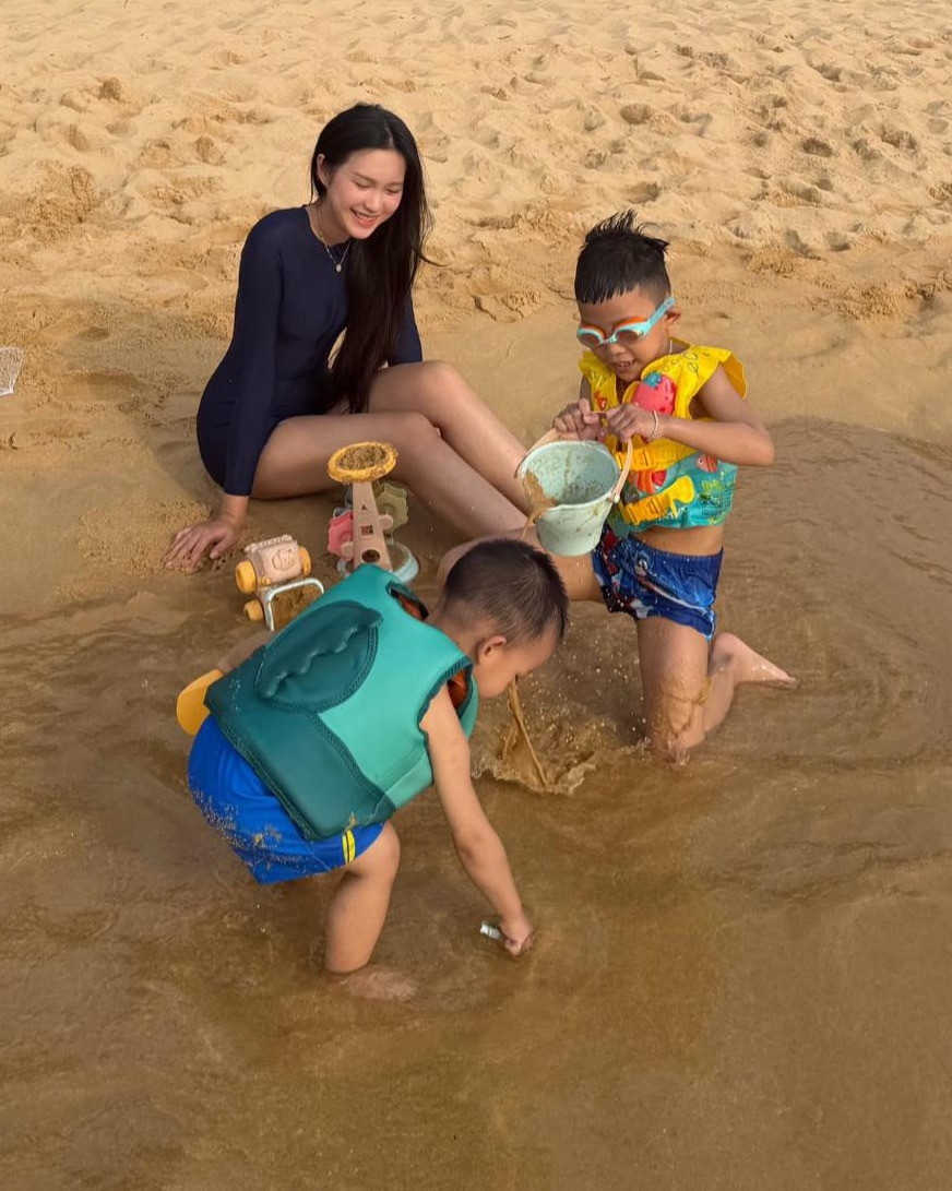 Doãn Hải My trông các cháu khi đi biển cùng gia đình. Sau sinh, bà xã Đoàn Văn Hậu vẫn giữ vóc dáng thon gọn.