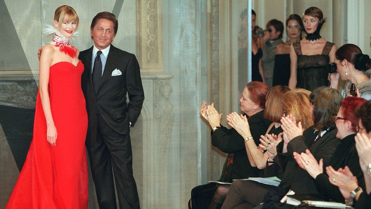 Valentino đứng cùng người mẫu Claudia Schiffer sau khi kết thúc buổi trình diễn bộ sưu tập xuân/hè 1998 của ông tại Paris. (Ảnh: AFP-JIJI)