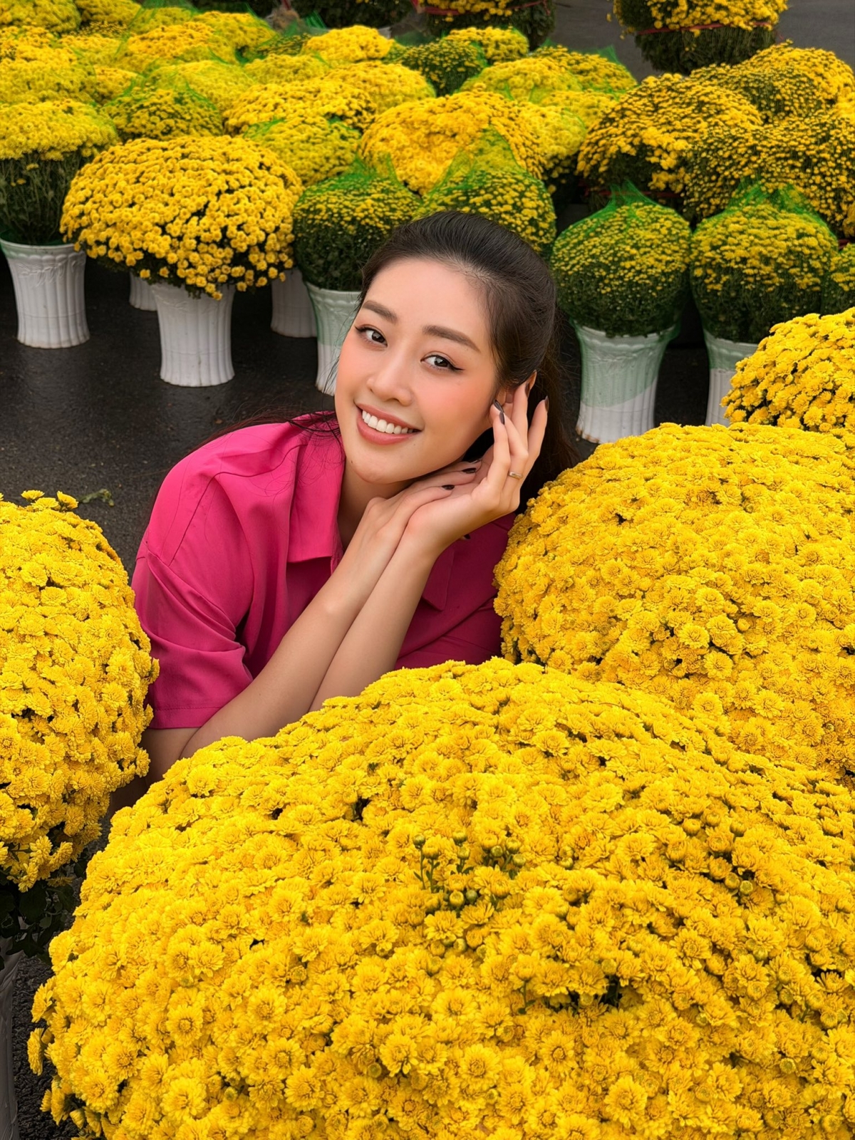 Hoa hậu Khánh Vân háo hức đi chợ hoa sắm Tết cùng ông xã Nguyễn Long. Được chồng chụp ảnh cho, Khánh Vân càng thêm rạng rỡ, thoải mái tạo dáng giữa chợ hoa xuân đông đúc. “Trang phục hồng hồng có hợp với chợ hoa Tết không ạ, cả nhà mua hoa Tết ủng hộ các cô chú nha”.