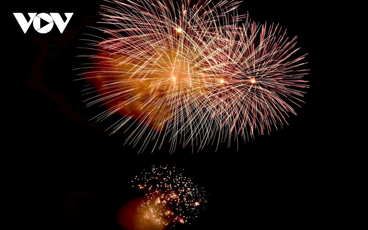 Cascading fireworks illuminate the night, casting a dazzling glow over the New Year festivities.