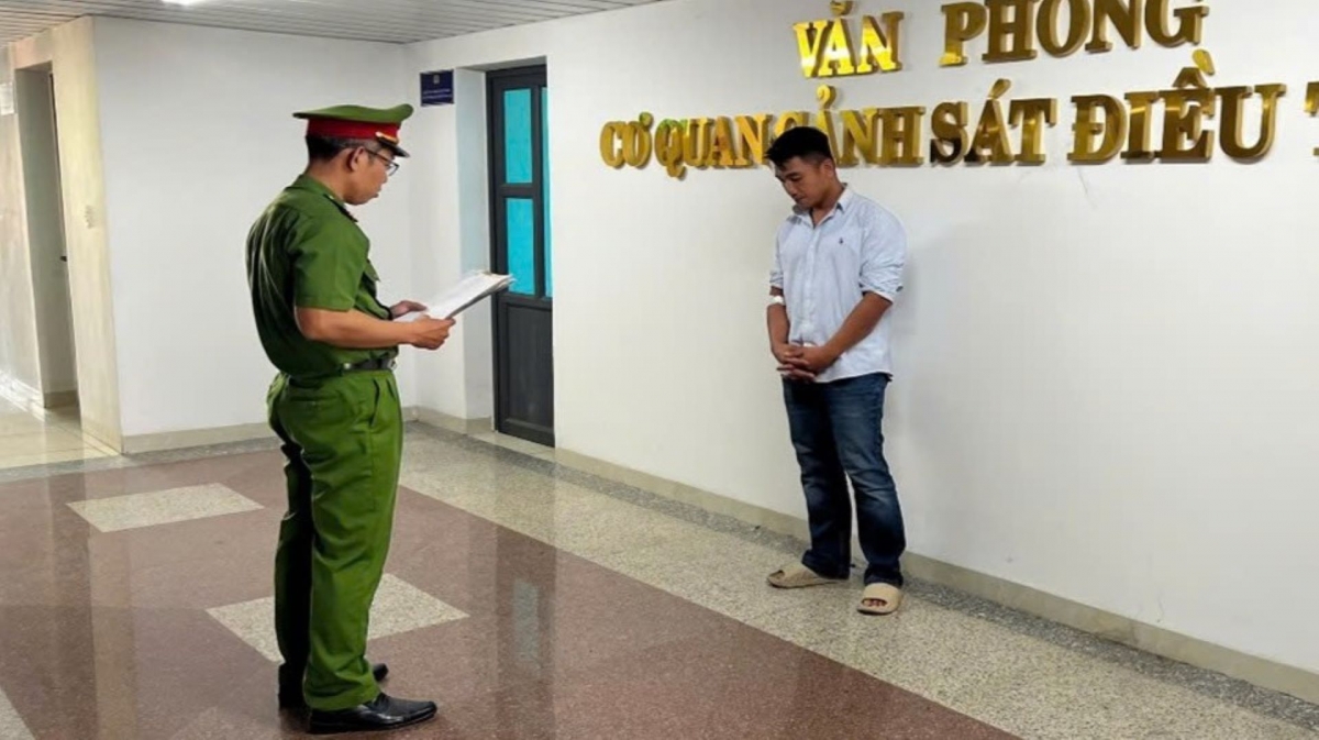 Cơ quan CSĐT tống đạt các quyết định khởi tố đối với Phạm Quốc Huy (Ảnh: công an cung cấp).