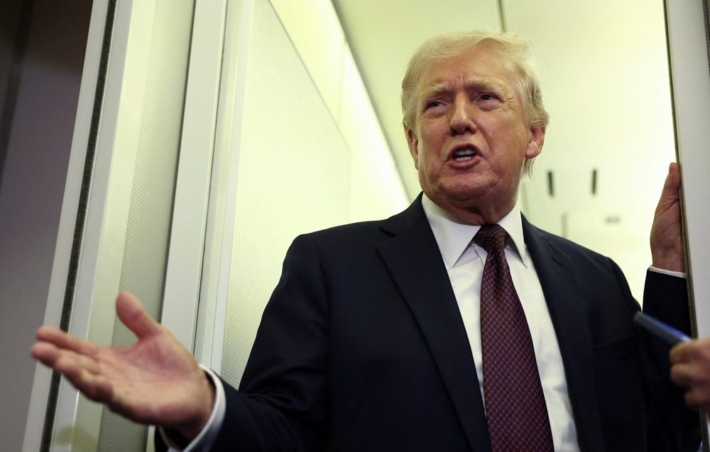 Tổng thống Mỹ Donald Trump phát biểu trước các phóng viên trên chuyên cơ Air Force One. Ảnh: Reuters