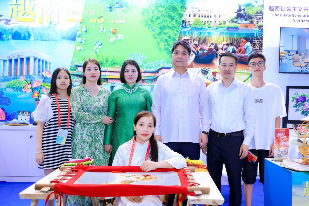 Nghệ nhân Phan Thị Anh trực tiếp thêu tác phẩm Hoa Mẫu Đơn tại Không gian Văn hóa Việt Nam tại khu vực triển lãm APEC. (Ảnh: Tổng Lãnh sự quán Việt Nam tại Quảng Châu)