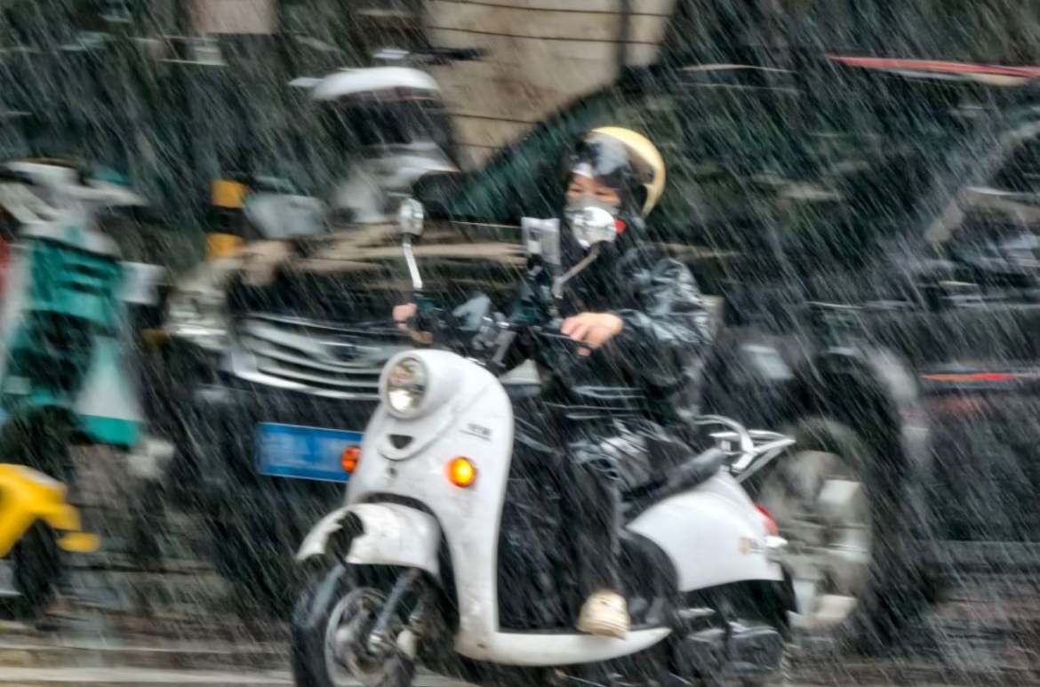 Một người dân đi xe máy dưới trời mưa ở quận Xixiangtang, thành phố Nam Ninh, Khu tự trị dân tộc Choang Quảng Tây, miền nam Trung Quốc. Ảnh: Tân Hoa xã